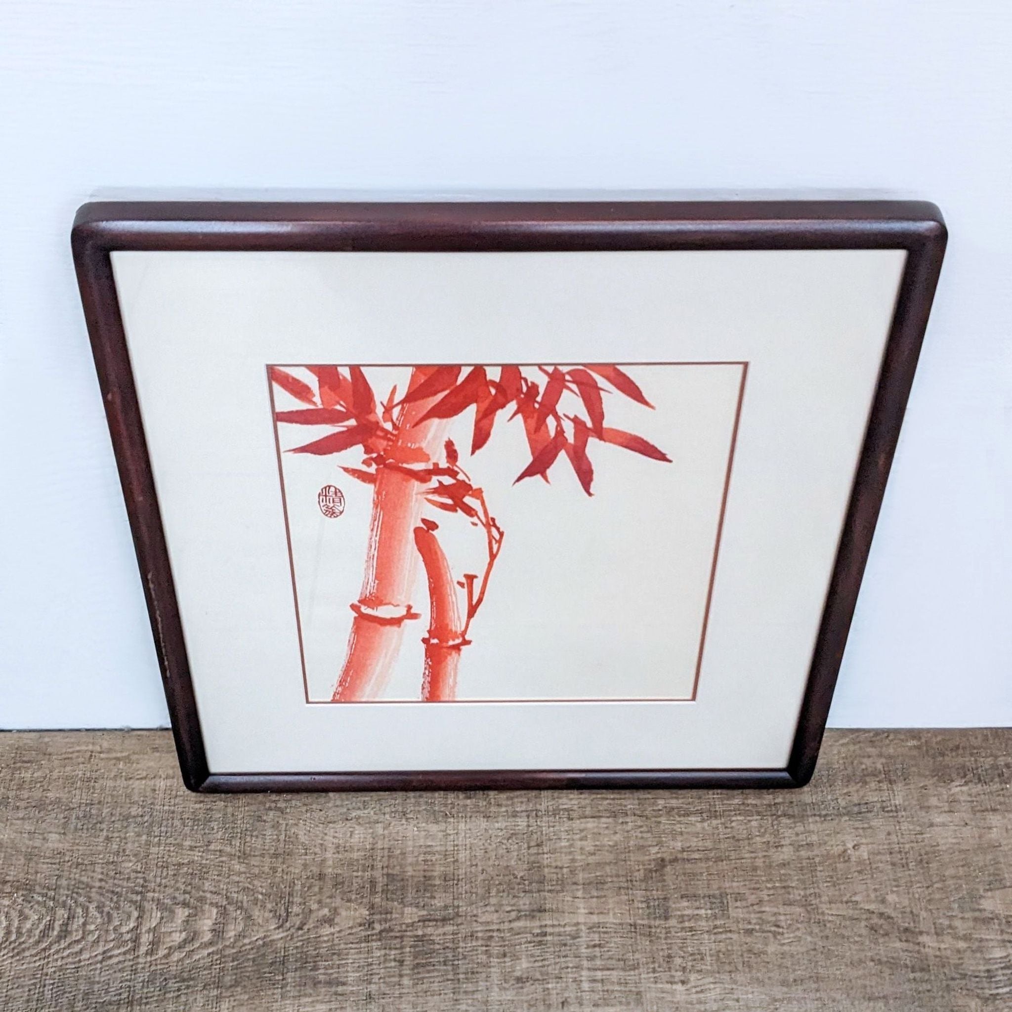 Alt text 2: Framed artwork from Reperch featuring an abstract design of bamboo in red shade, enclosed in a glass cover for elegant wall display.