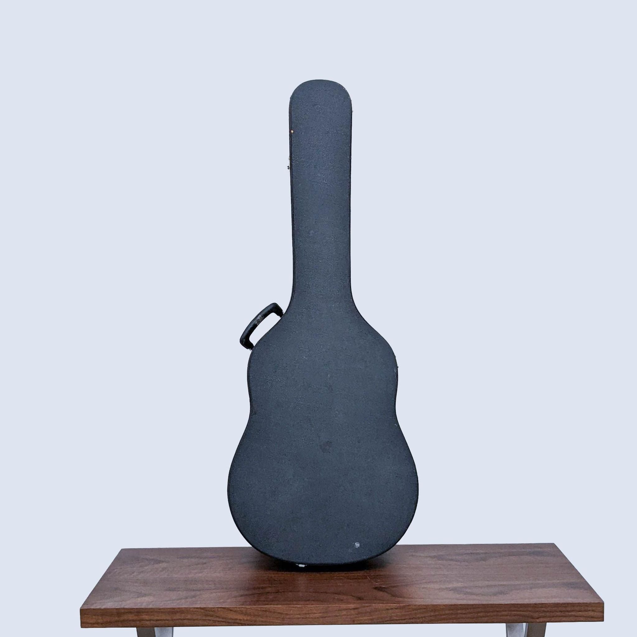 Morris MD-51M guitar inside a closed case on a wooden table against a grey background.