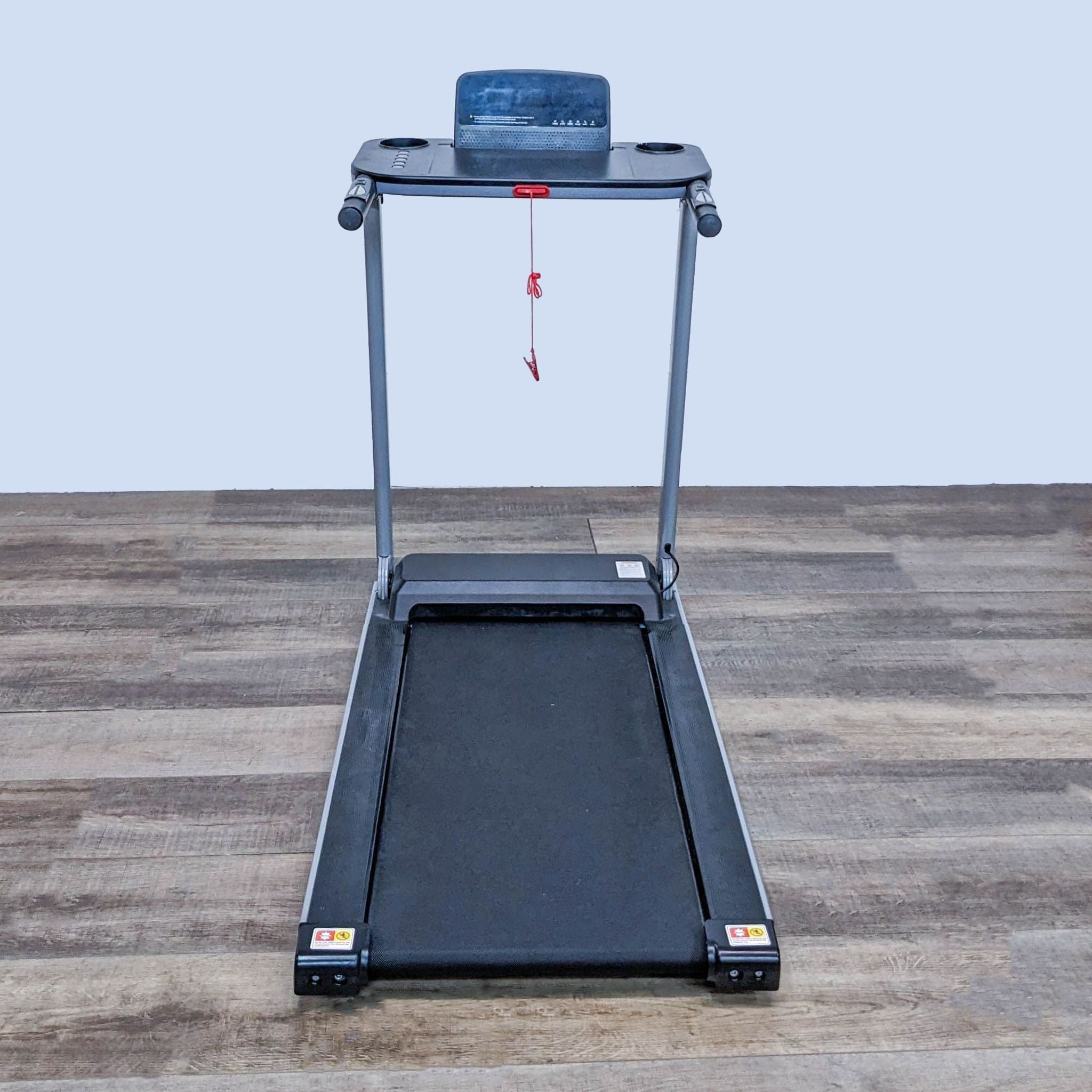 Front view of a Funmily treadmill with a black belt, metal frame, and attached LCD monitor on wooden flooring.