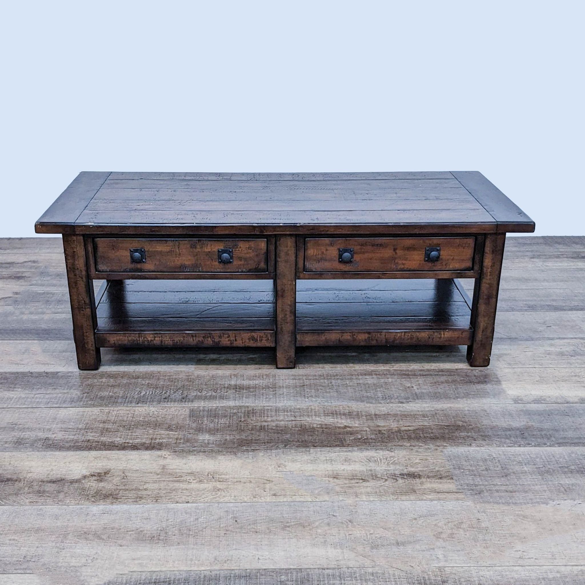 Reperch Coffee Table: Planked top, multiple drawers with metal handles on wooden flooring.
