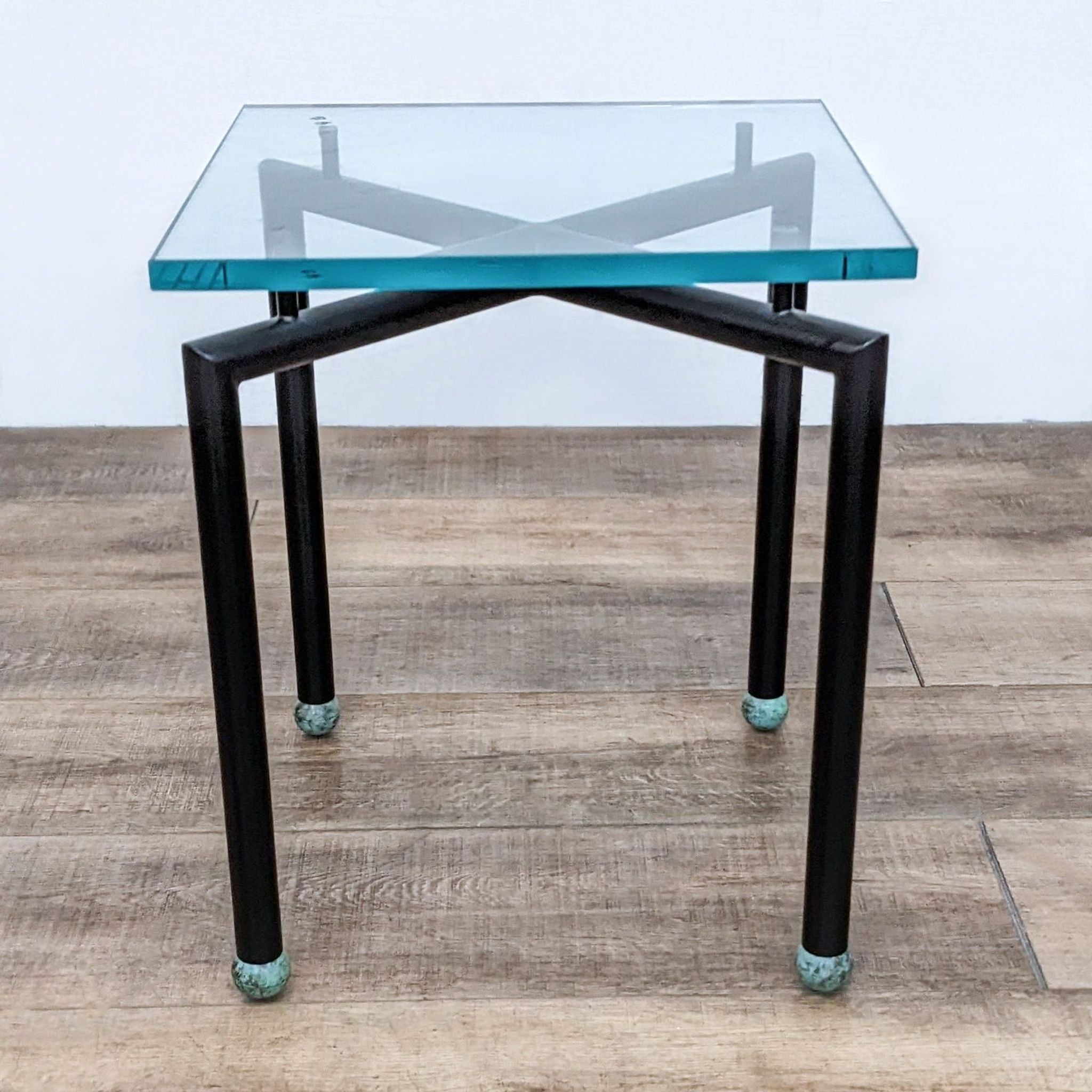 Reperch-branded side table with metal base and square glass top, featuring unique X-shaped supports.