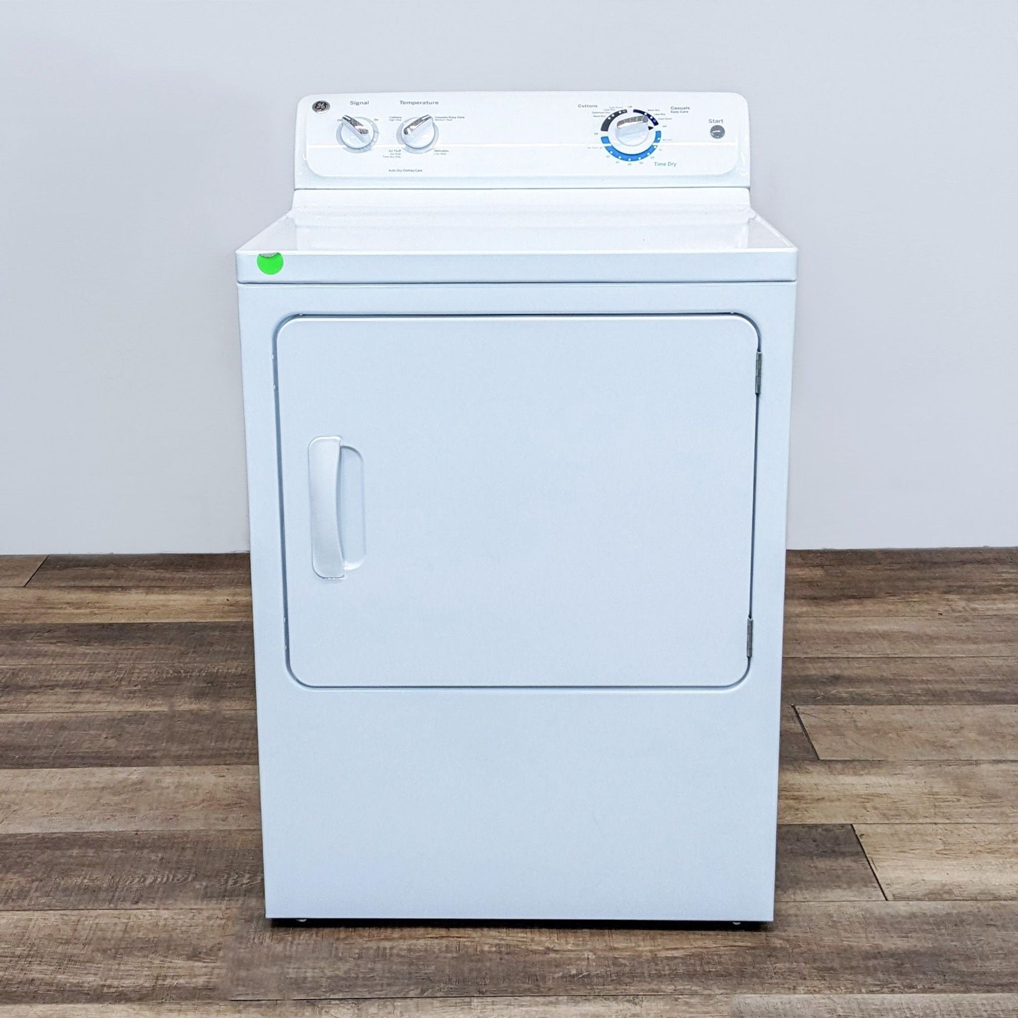 GE washer/dryer in a front view, showing control panel and closed door.