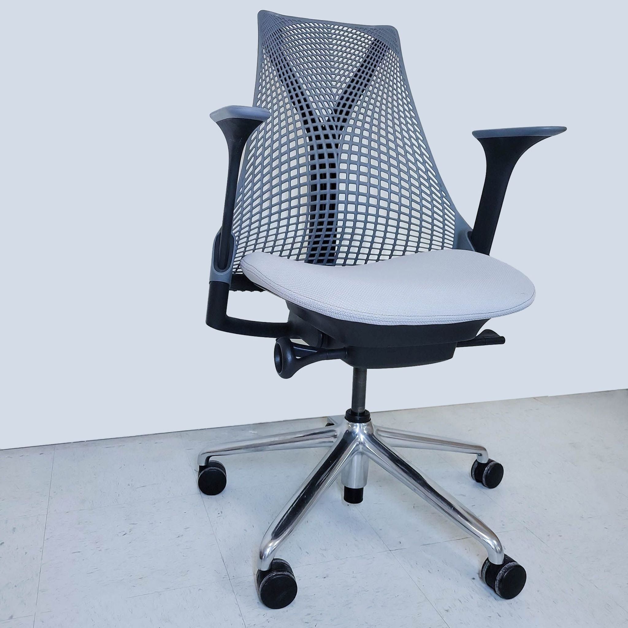 Herman Miller brand ergonomic mesh office chair with adjustable arms and a five-star base with casters.