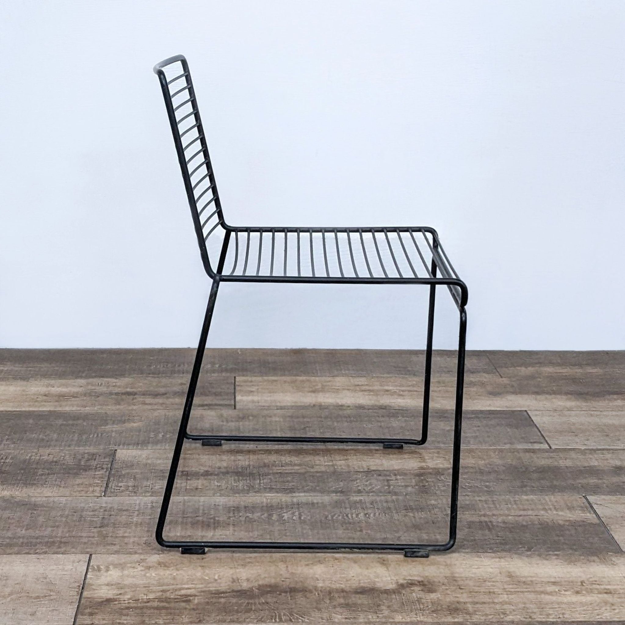 Side angle of the Hee dining chair by Hay revealing its profile, constructed of steel suitable for both indoor and outdoor use.