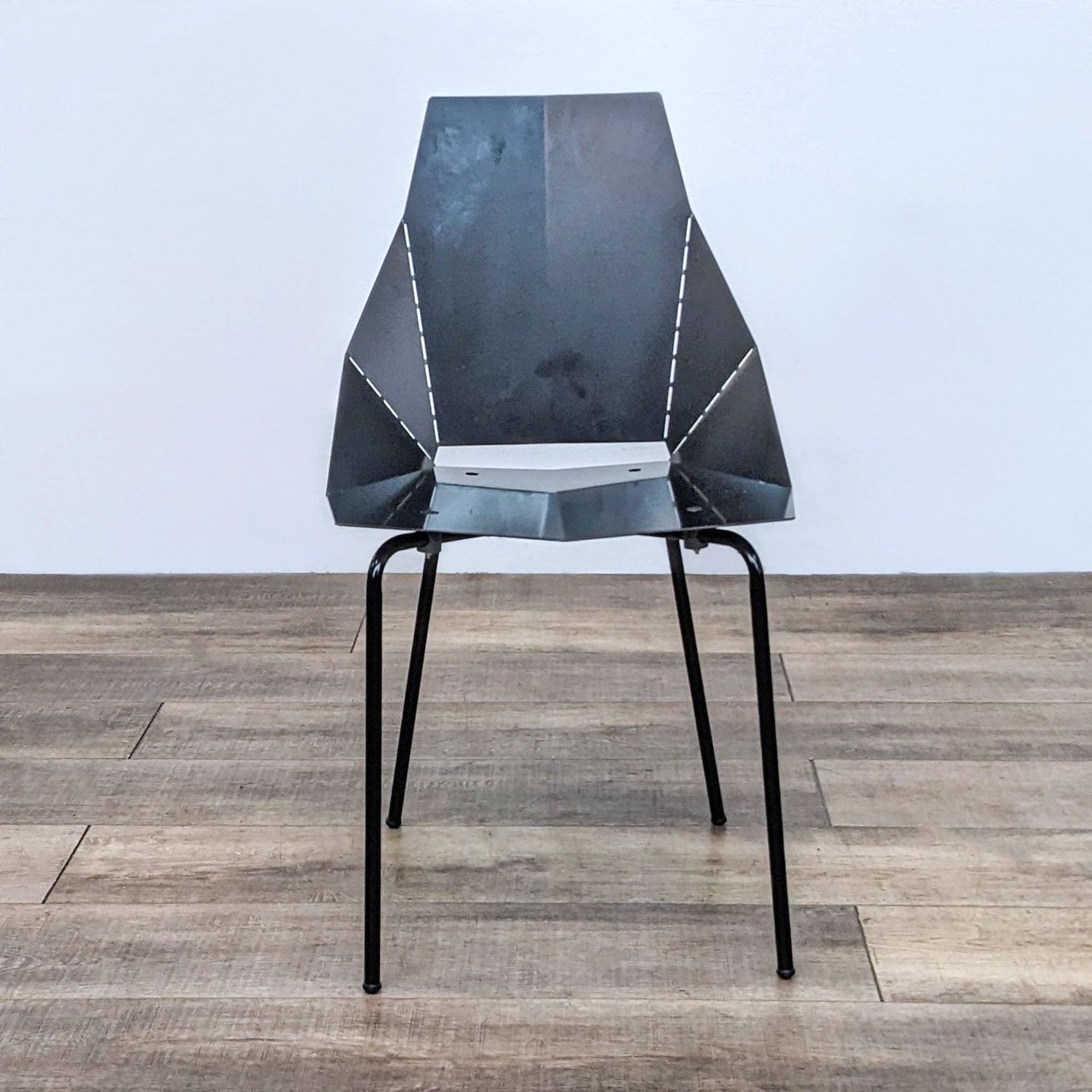 Industrial modern Blu Dot Real Good Chair crafted from powder-coated steel, showcased in a clean interior.