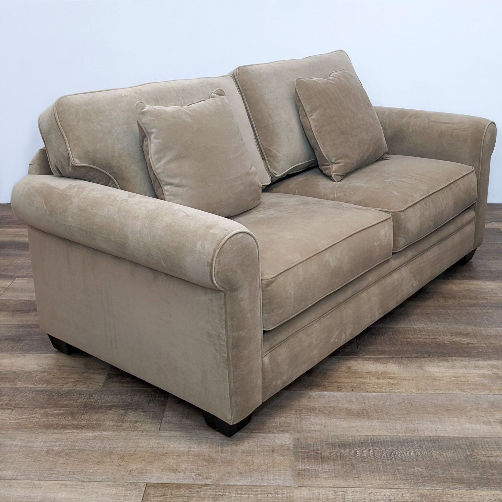 Three-quarter view of a Reperch 3-seat compact sofa with classic design, narrow rolled arms, and dark feet on wooden flooring.