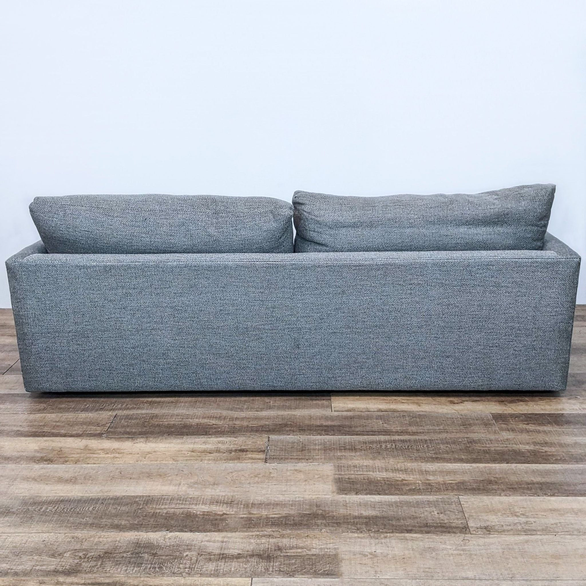 Crate & Barrel exclusive 3-seat modern sofa with deep seats, slim track arms, and soft back cushions.