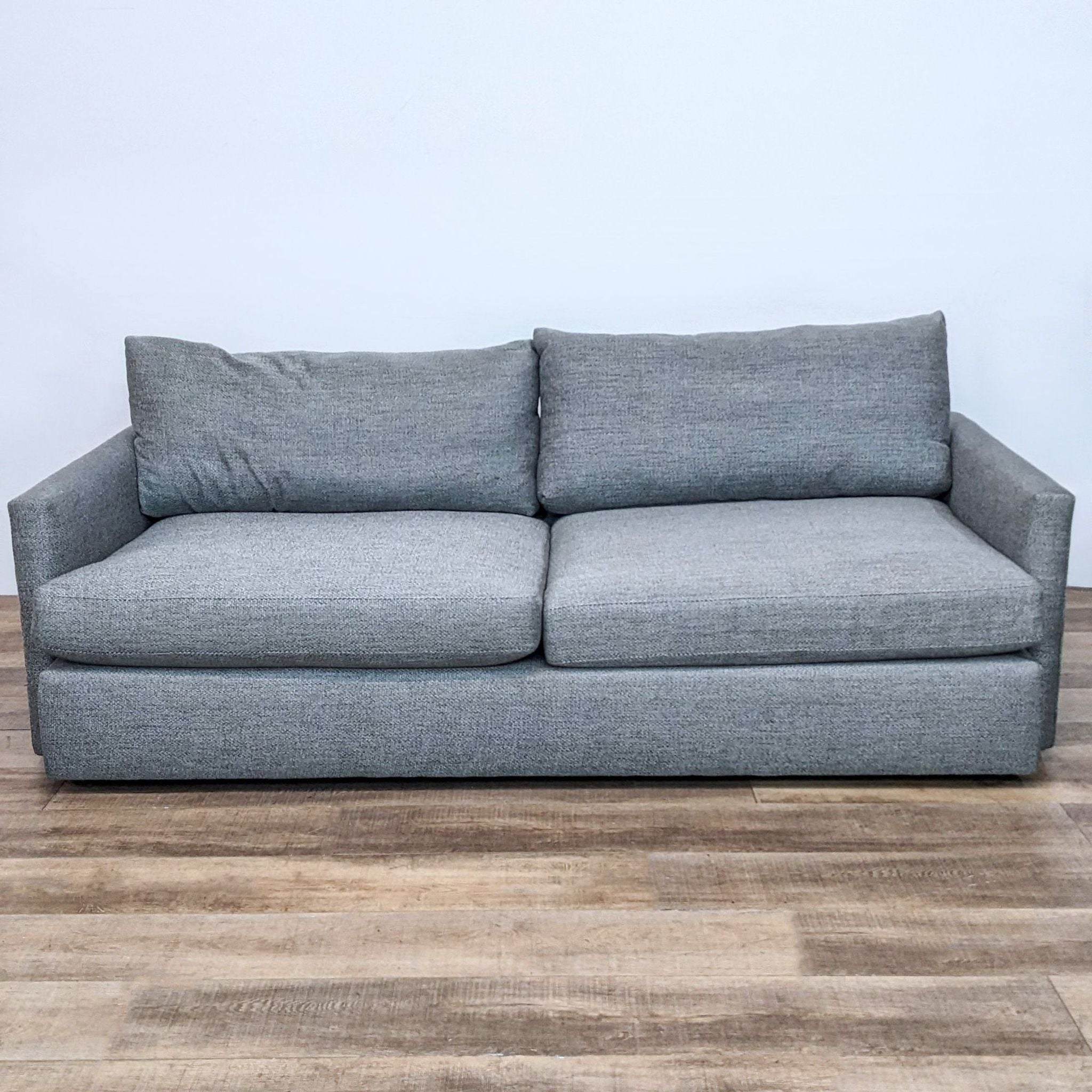 Extra-long modern 3-seat sofa by Crate & Barrel with deep seats and soft back cushions, featuring slim track arms.