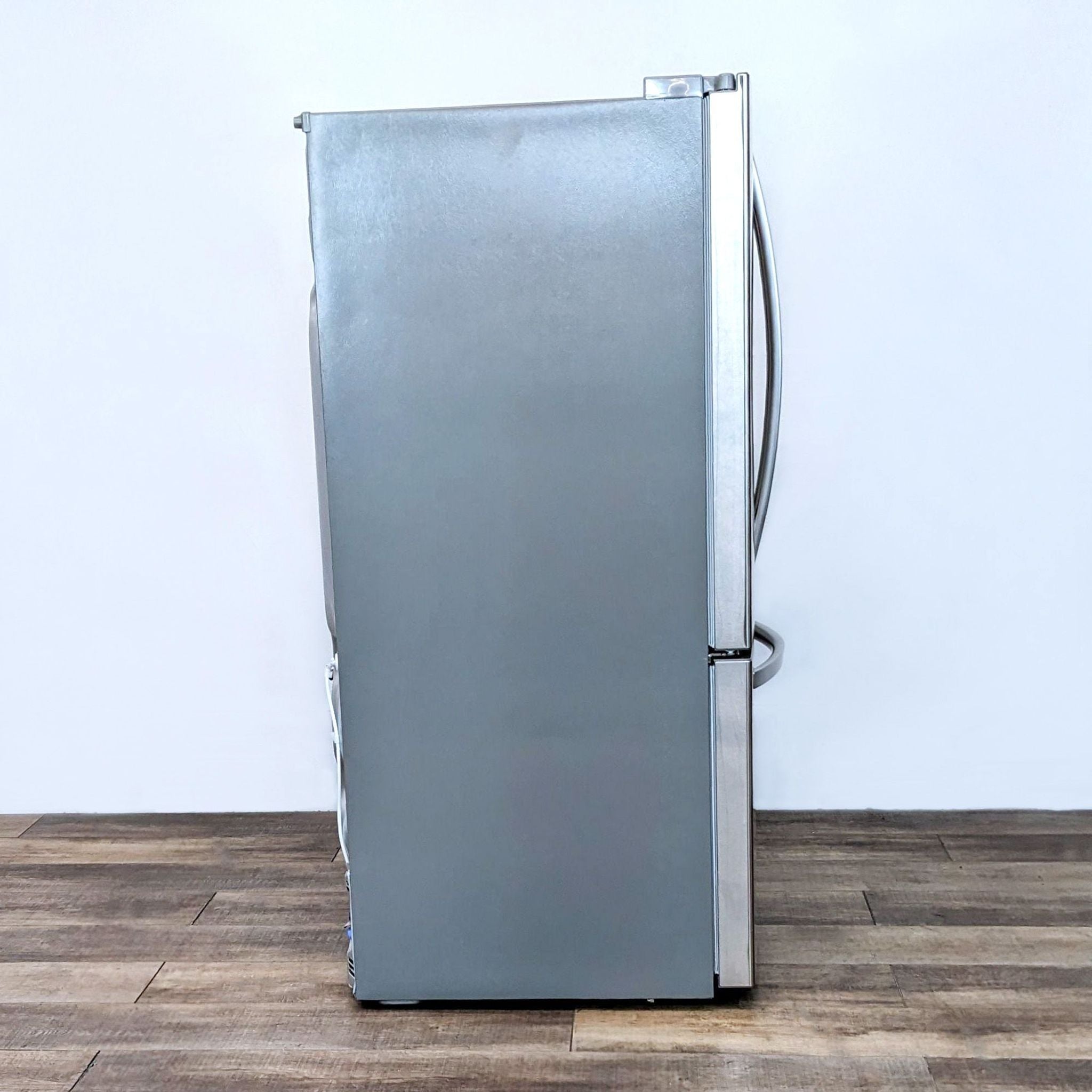 Side view of a stainless steel LG French Door Refrigerator showing the slim profile and closed doors.