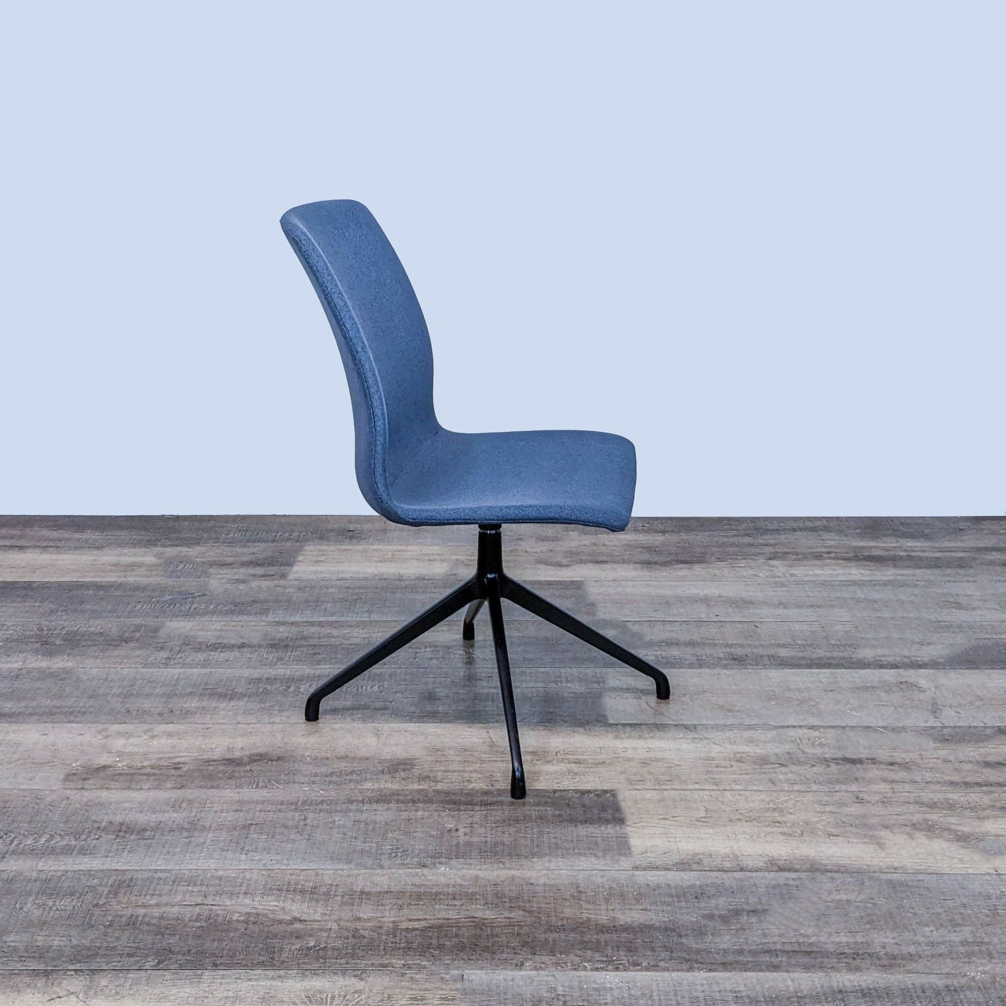 Alt text 2: Ergonomic blue fabric OFS Hairpin chair with powder-coated steel base, angled view on wooden floor.