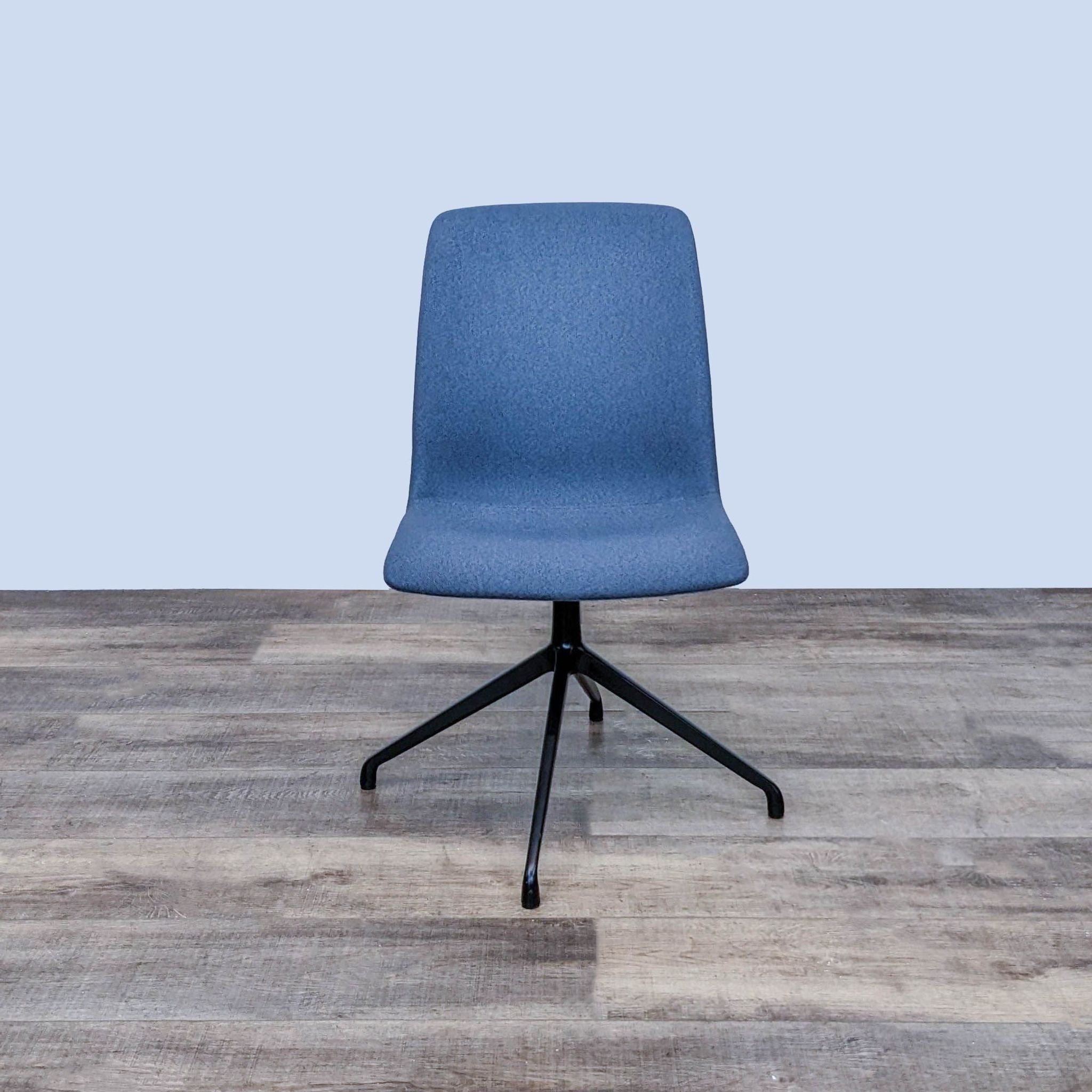 OFS brand Hairpin side chair with blue upholstered ergonomic seat and black steel base on a wooden floor.