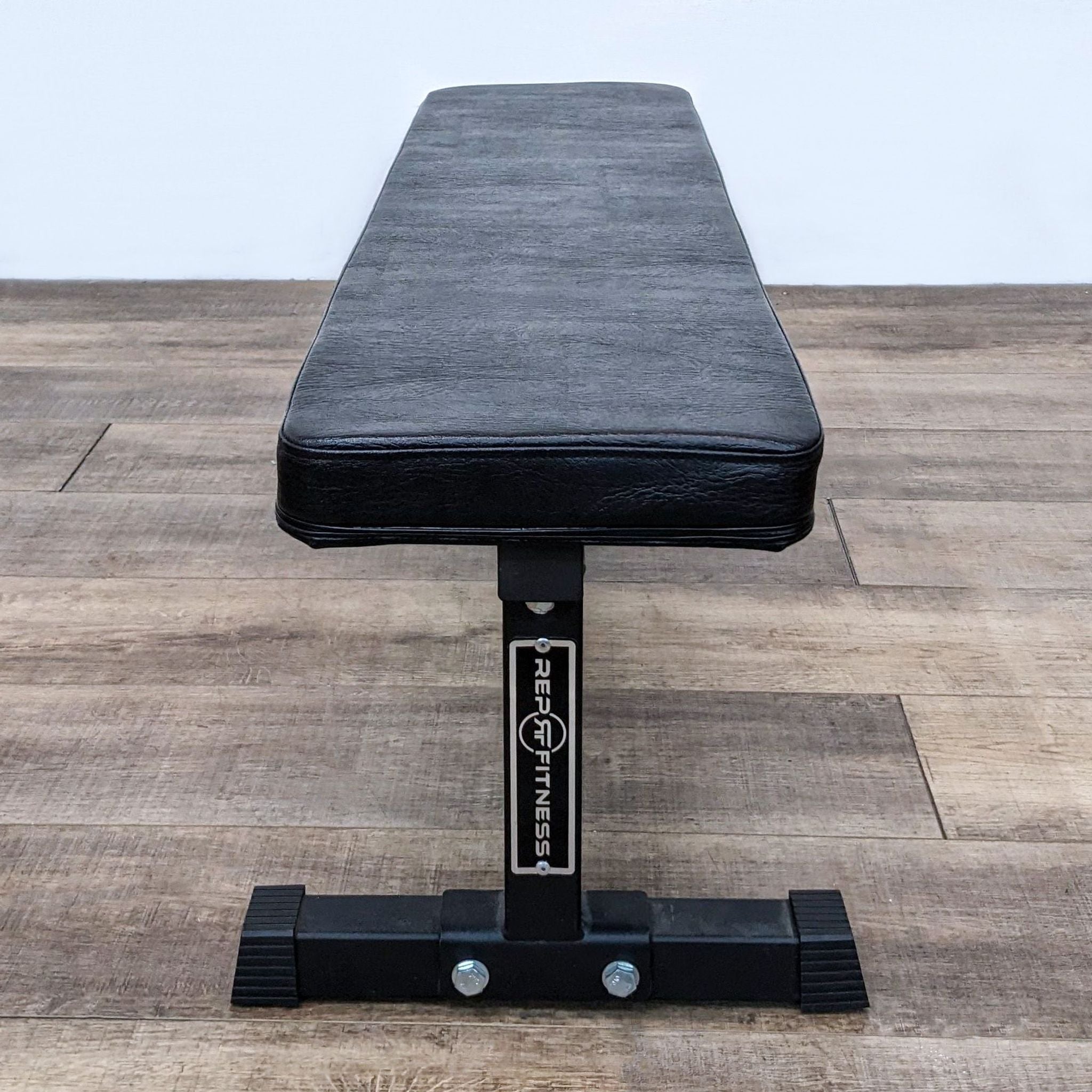 REP Fitness solid steel flat bench for home gyms and competitive lifting, stable for various exercises. 