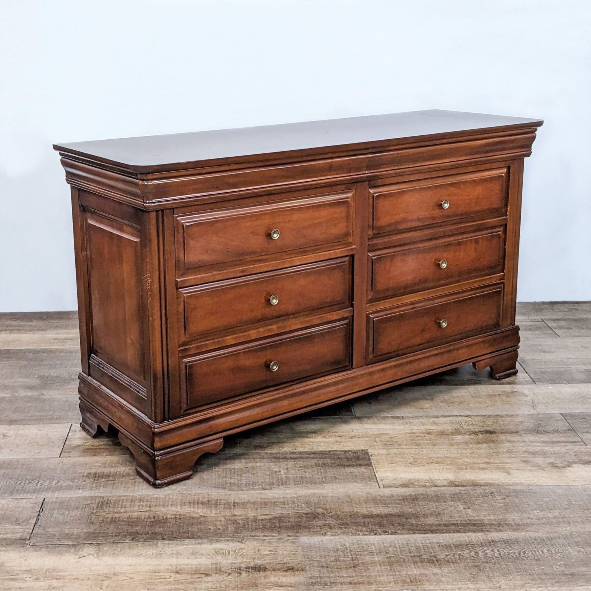 Reperch traditional 8-drawer dresser with antique brass metal knobs and dovetail joinery on a wooden floor.