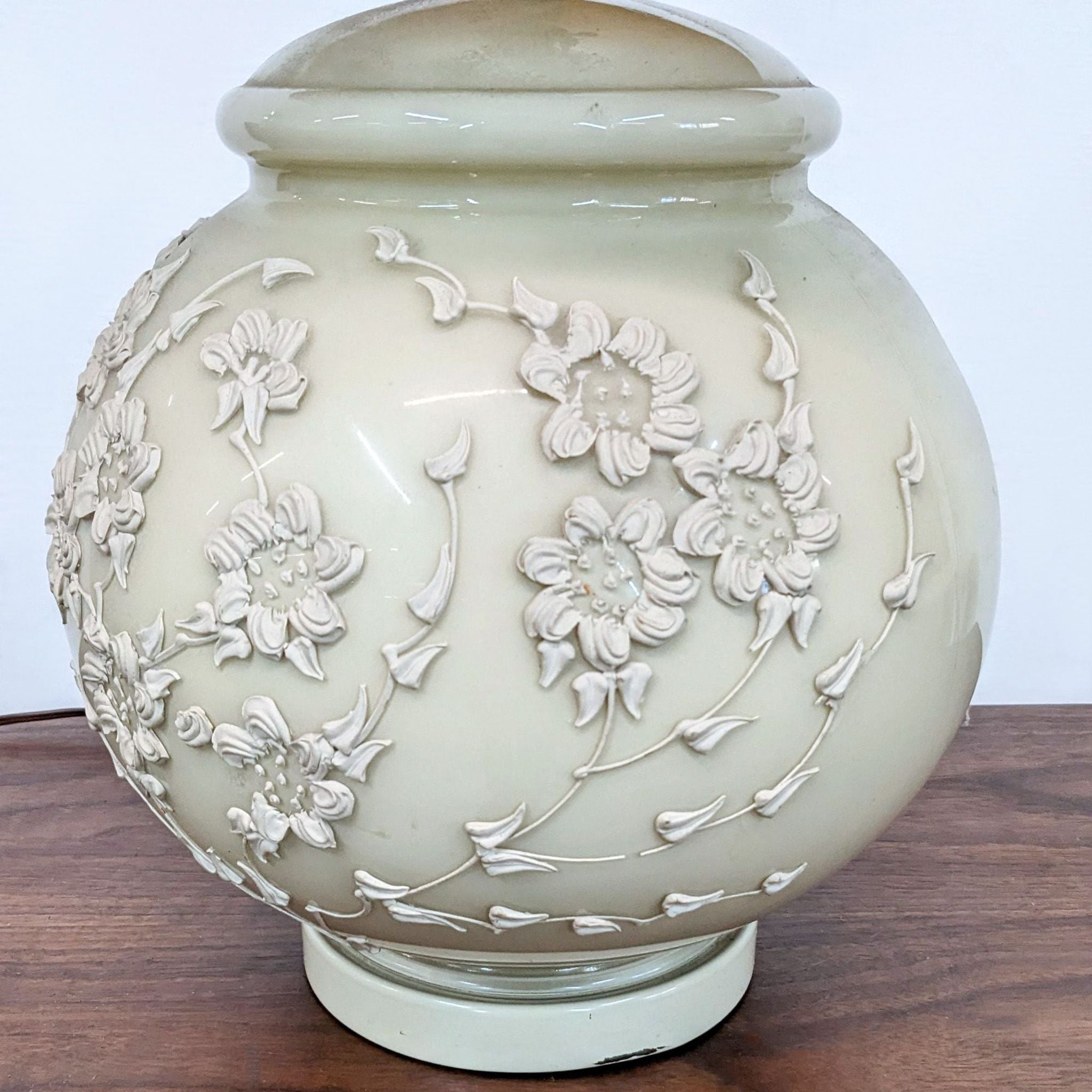 Alt text 2: Close-up of a Reperch floral embossed lamp base in cream, showcasing detailed flower and vine textures.