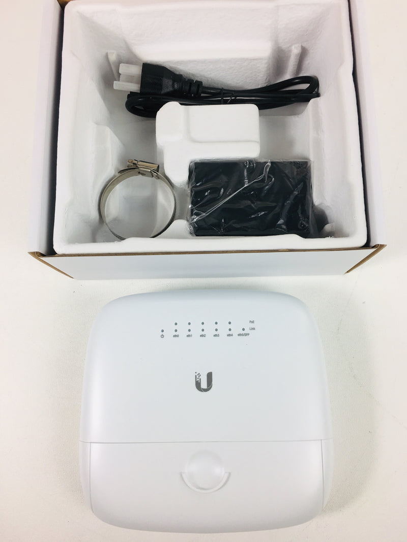 Image 1 alt text: Ubiquiti networking device with accessories in a white box, including a power adapter and a metal mounting ring.