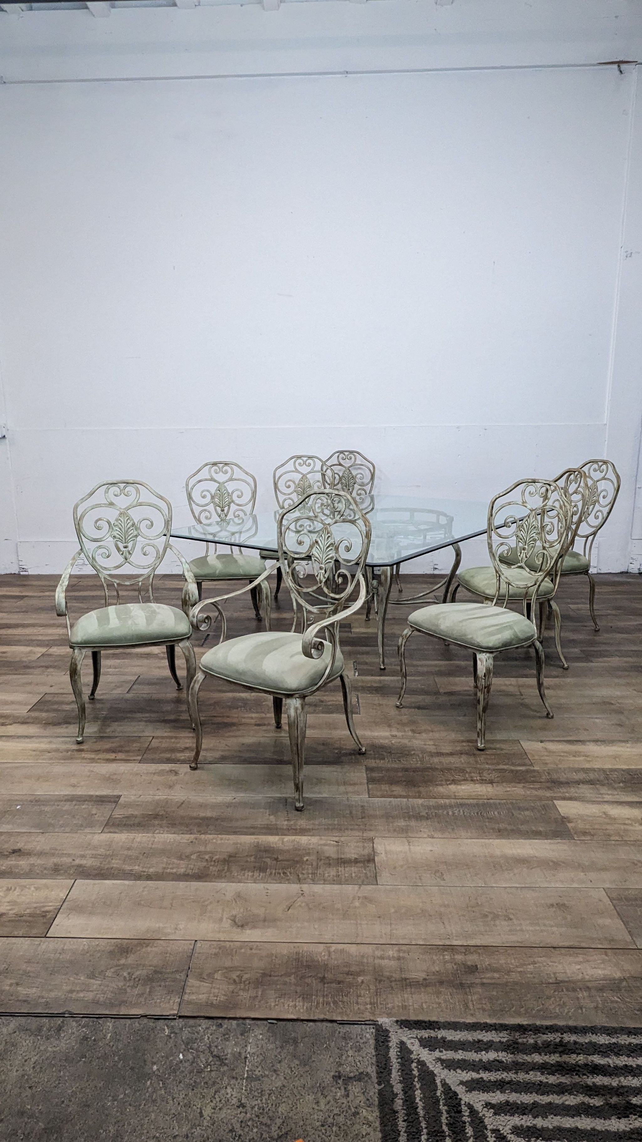 Artistic Metal Designs 9-piece dining set with glass table and metal scrollwork base, 6 chairs, 2 armchairs with suede seats.