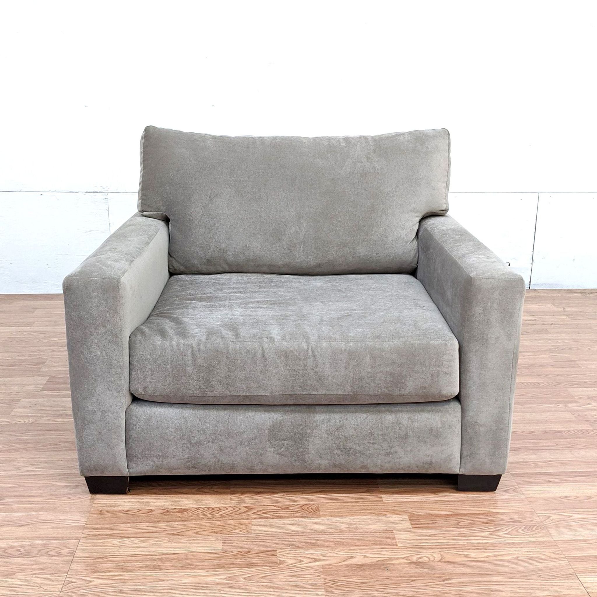 Front view of a Reperch brand lounge armchair in grey with plush cushions.