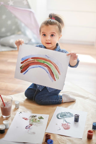 young girl showing her work of art