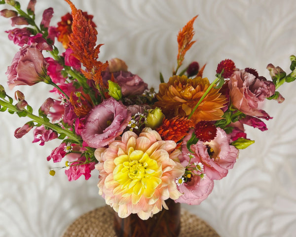 Deluxe arrangement of seasonal August flowers.