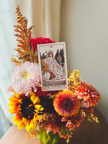 Fall flower arrangement with a The Empress tarot card sitting on top