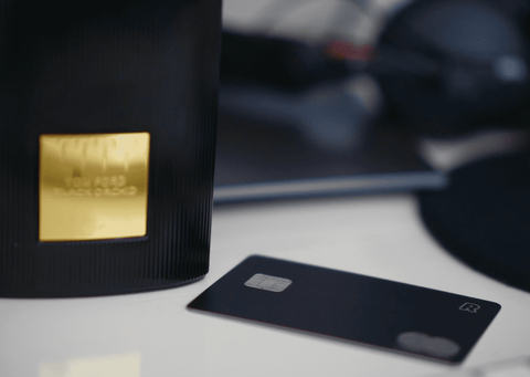 bottle of tom ford's black orchid perfume next to a credit card