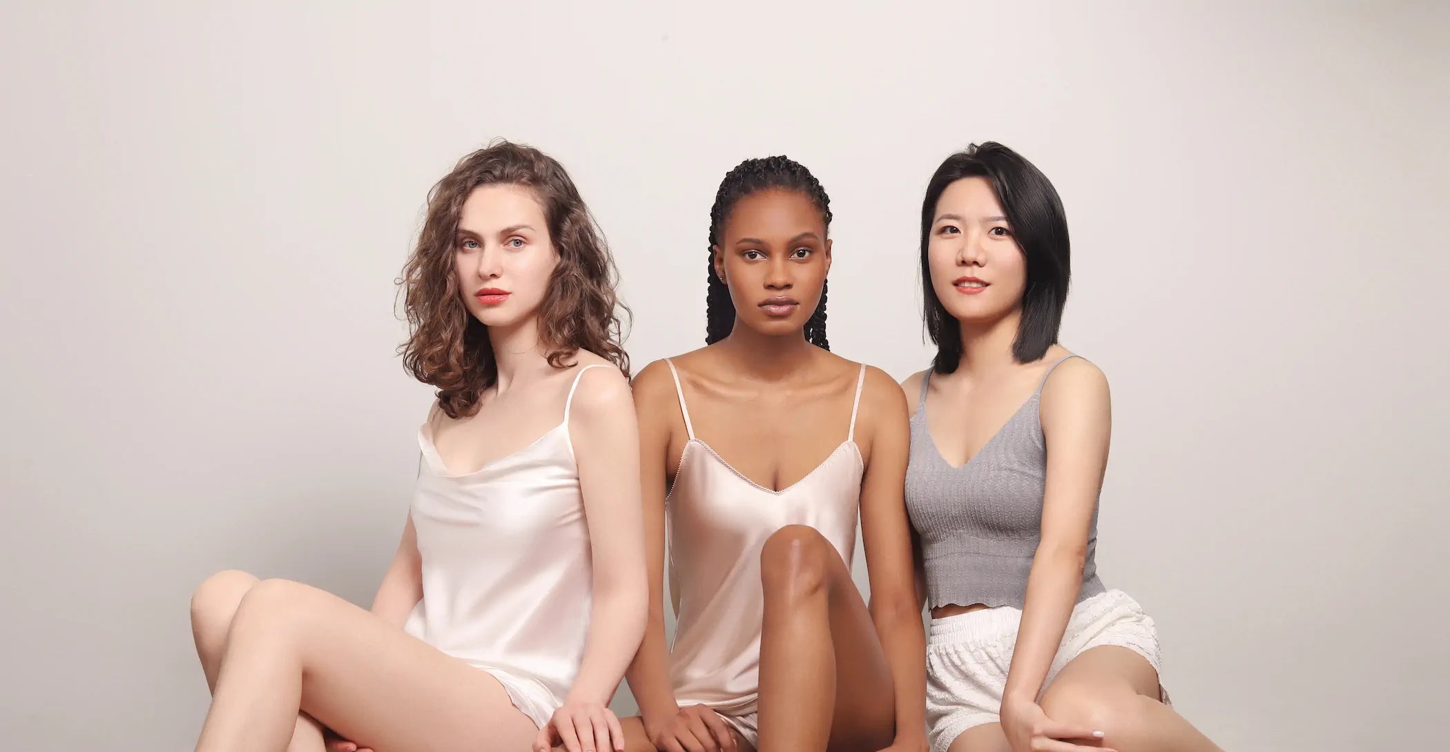 Three beautiful models embracing each other.