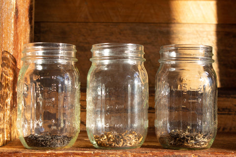 3 mason jars of black tea illustrating how different leaf shapes create different volumes versus weight