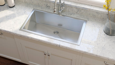 Stainless steel sink on white quartz top