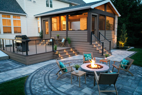 Outdoor living space with Deckorators decking and railing and outdoor lighting with fire pit