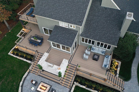 Outdoor deck living space with outdoor kitchen and fire pit