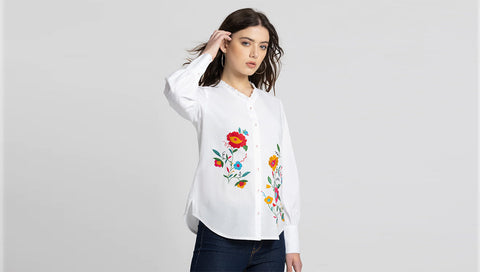 Women wearing white colour top with flowers embroidery