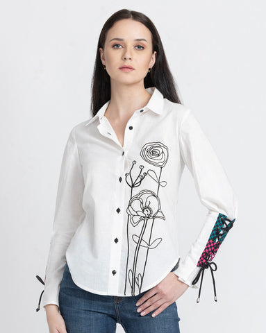 Women wearing white top with flower design