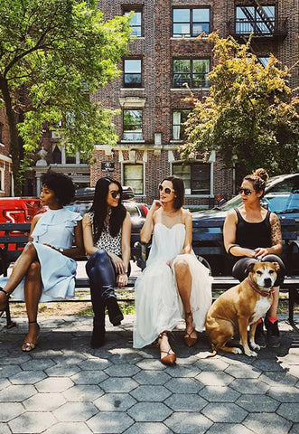 Females sitting under tree in a park