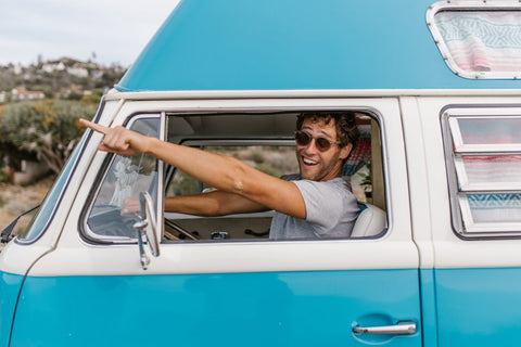 male in campervan wearing sunglasses