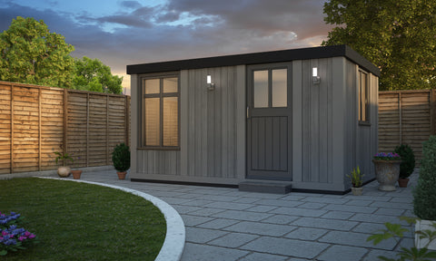 A small insulated garden office pod in the evening.