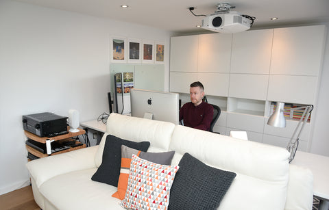 A man working at a desk in his garden room in Cheshire