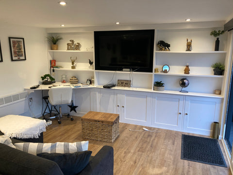 Interior of a garden room office in Chester with a large TV on the wall