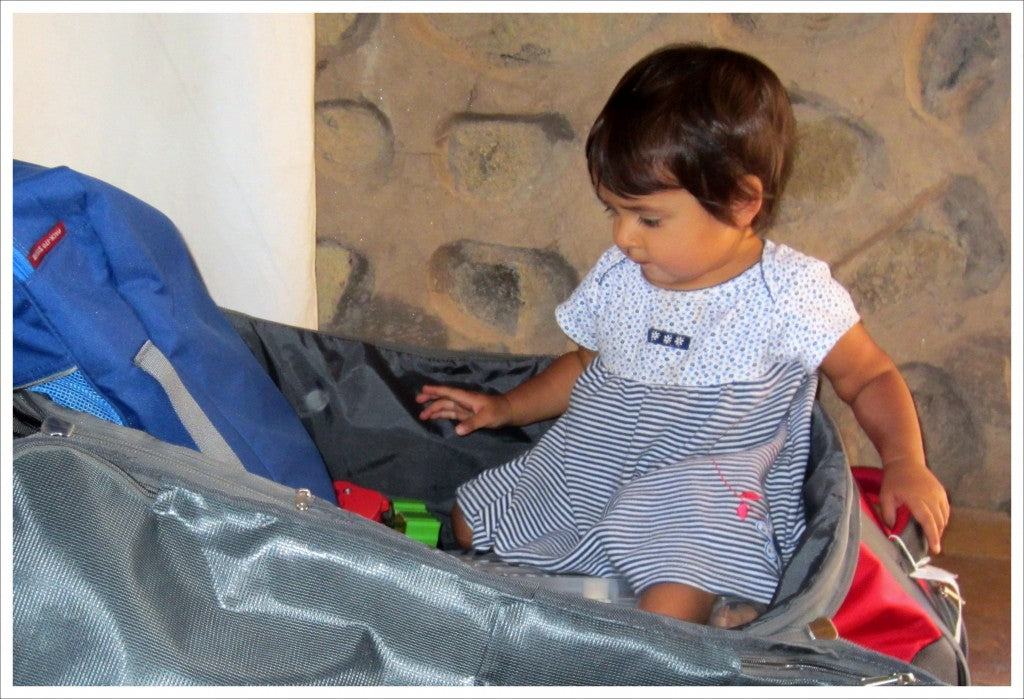 Child helping mom pack for a travel trip