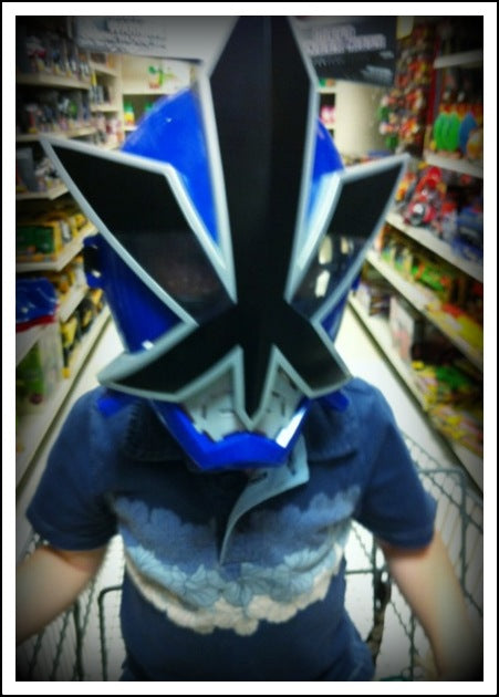 Parent and child having fun shopping with matching super hero masks