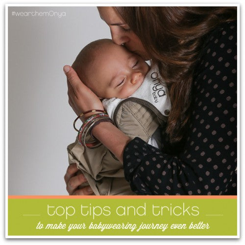 Mother gently kissing baby in her Onya Baby Carrier