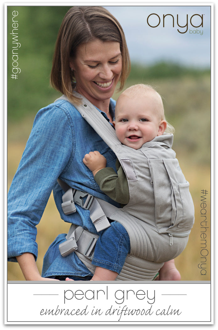 Woman carrying baby in Pearl Grey Onya Baby Cruiser