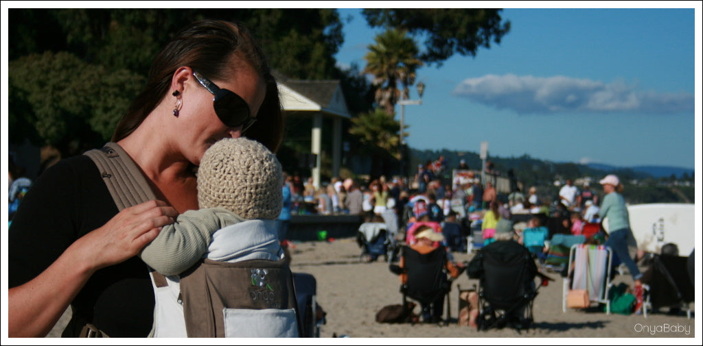 Mother with baby in an Onya Baby Carrier at the beach