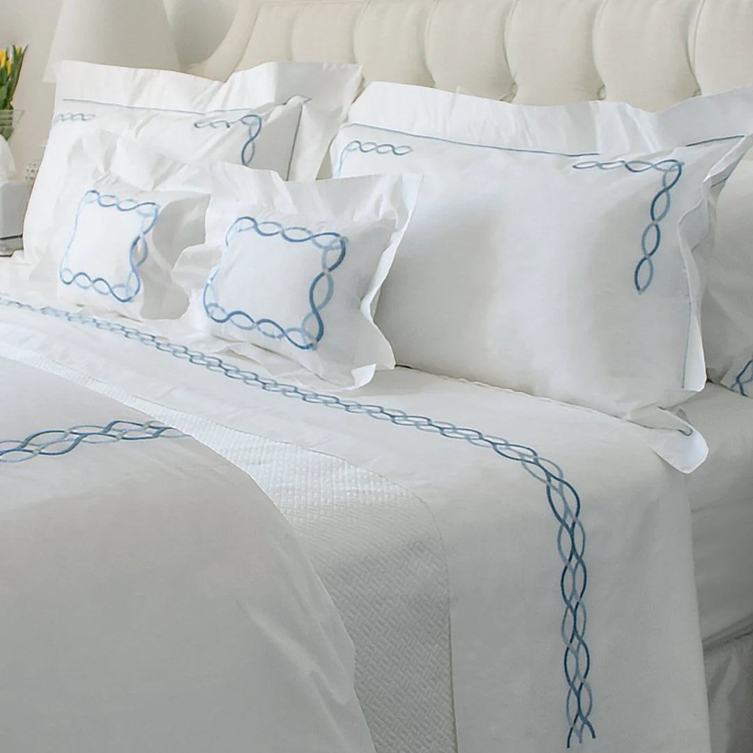 White bed with blue sheets to decorate your bed