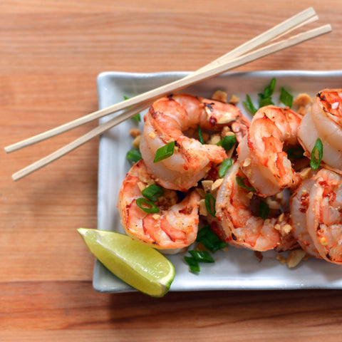 Garnish with lime wedges, chopped peanuts, and scallions, and serve immediately