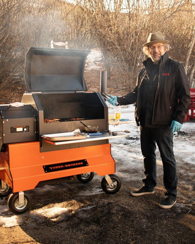 Man Cooking On Yoder Smoker YS640s with Competition Cart