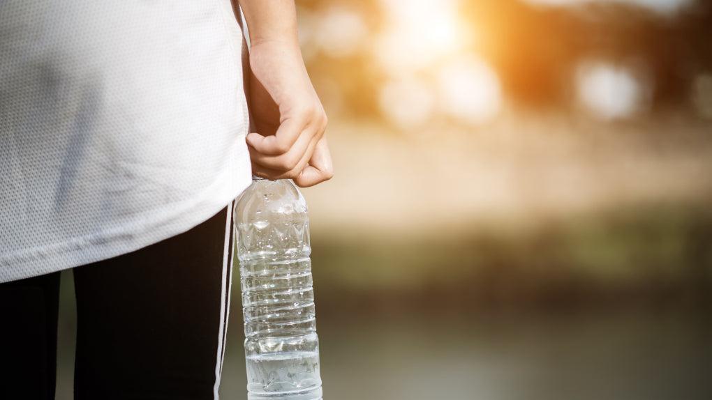 woman holding a water bottle