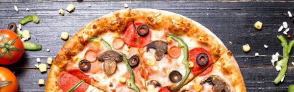 close up image of half a pizza with olives, pepperoni and green peppers