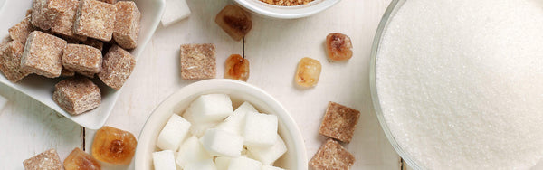 close up image of a white table filled with different variants of sugar