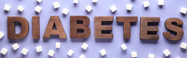 a purple table top with sugar cubes and wooden letters spelling out DIABETES