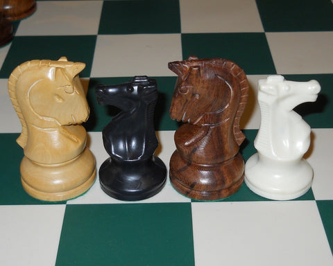 dubrovnik style knight chess pieces next to staunton style knight pieces